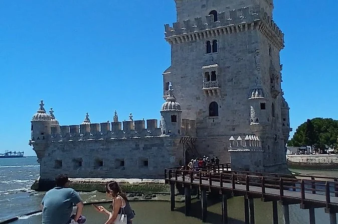 Belém Tower and its wooden footbridge under a clear blue sky