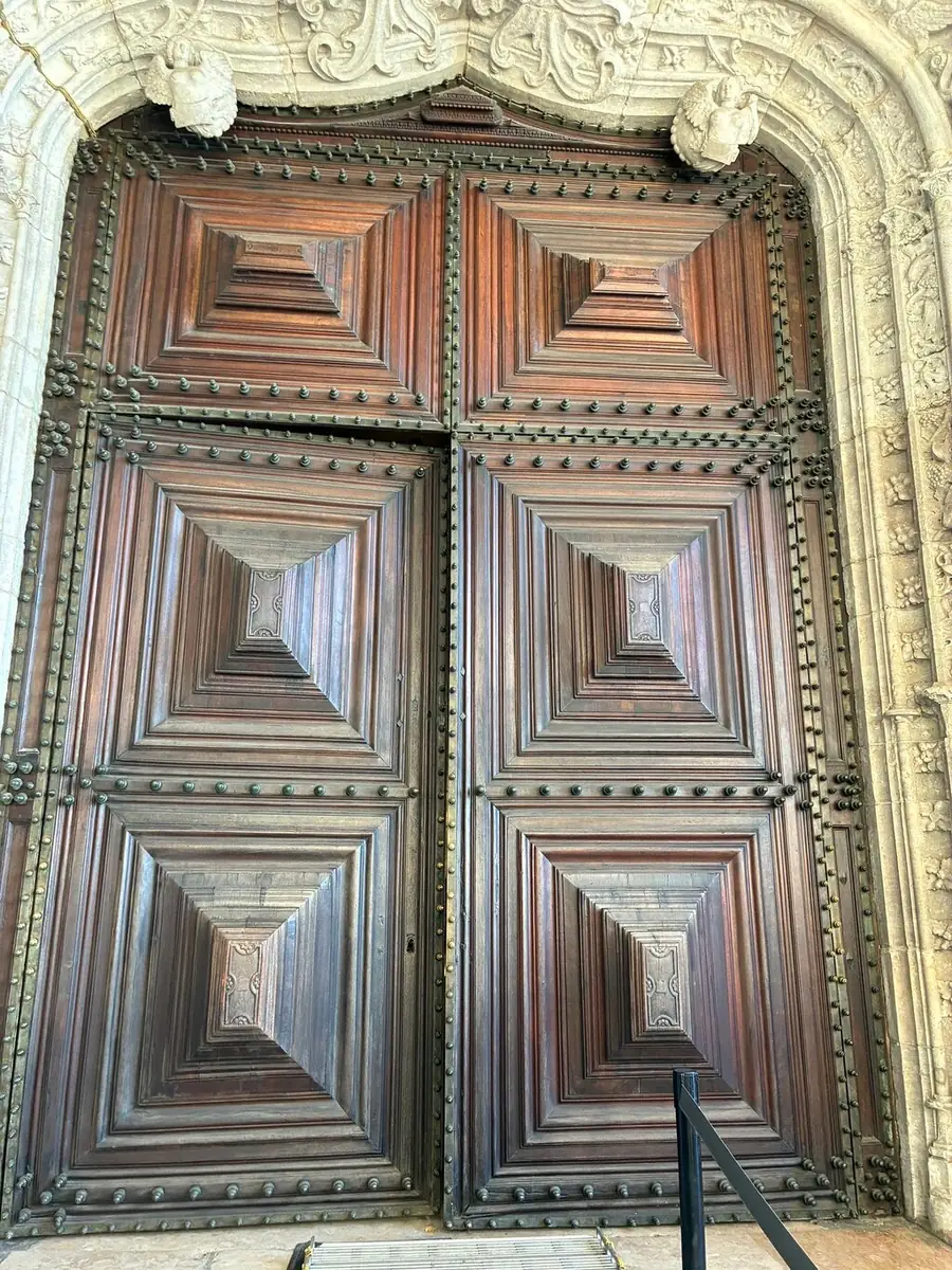 A carved wooden door set in a stone portal